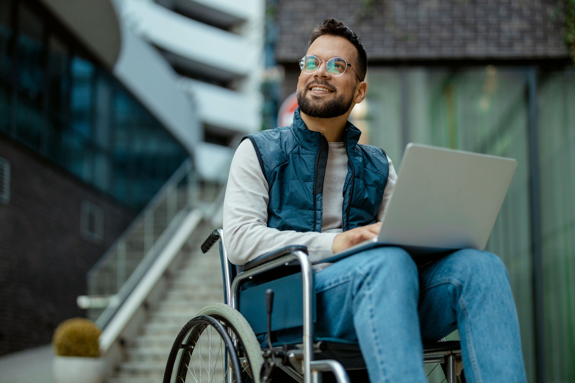 Handicapped Man With Laptop in Wheelchair Outdoors